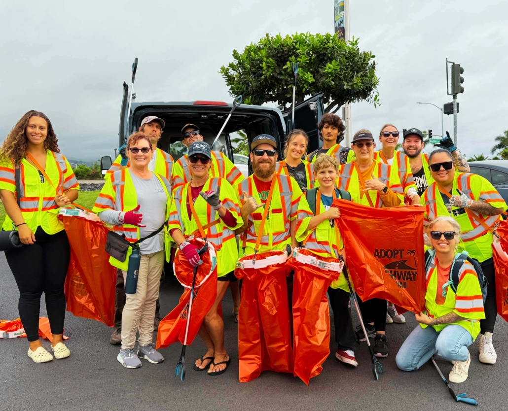 Fair Wind staff wearing high visibility vests cleaning up a highway in Kona.