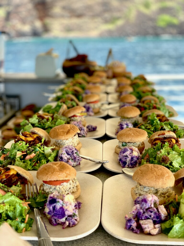 A lineup of plates loaded with delicious plant based food aboard the Fair Wind.