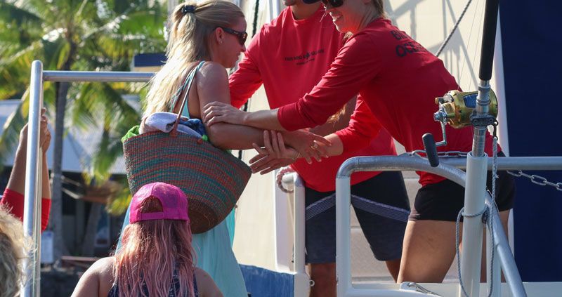 Crew Helping Boarding The Fair Wind Boat