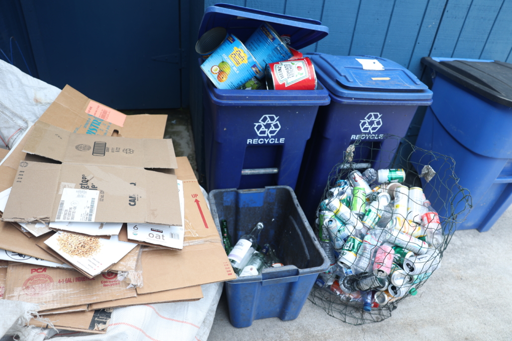 recycle Recycling bins full of cans, glass, and cardboard.